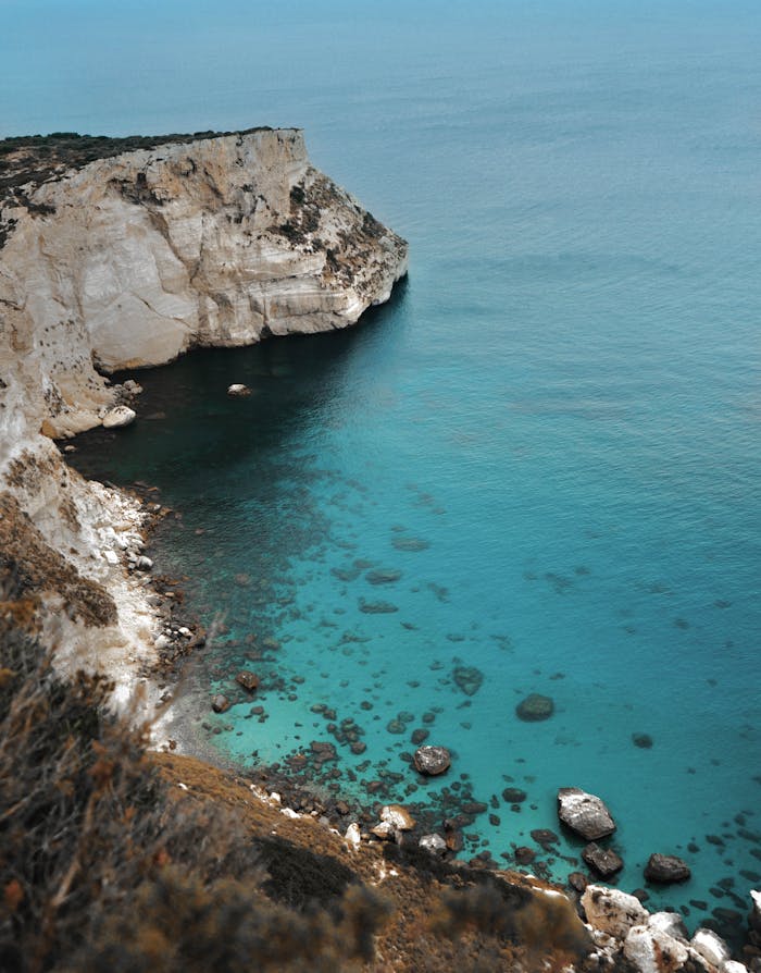 Stunning aerial view of Sardinian cliffs and turquoise waters. Perfect for travel and nature photography.
